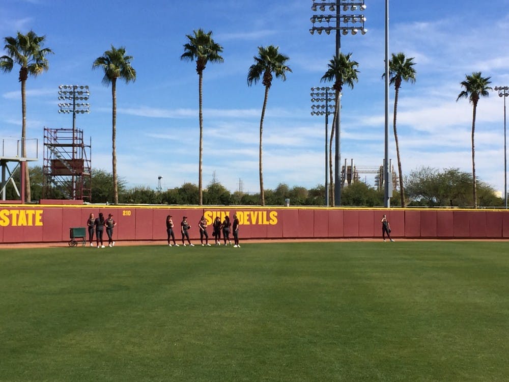 Non-participants in the "Dinger Derby" wait for fly balls in the outfield at Farrington Stadium in Tempe on Jan. 25, 2015. (Ryan Clarke/ The State Press)