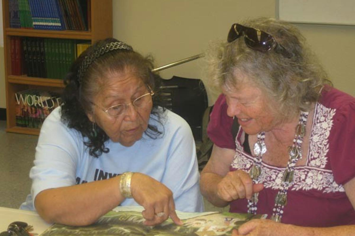 DYING LANGUAGE: Elder and fluent Mojave speaker Delphina Yrigoyen (left) and Language Revitalization Expert Leanne Hinton look through a book at the "Inyech Makavch Ithuum," or "I am Mojave" event in September. The Indian Education Center at ASU is working to save the Mojave language. (Photo Courtesy of Natalie Diaz)