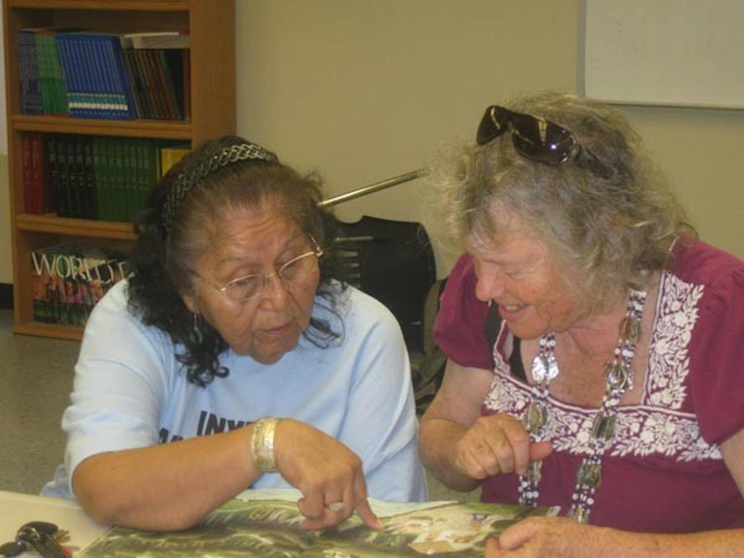 DYING LANGUAGE: Elder and fluent Mojave speaker Delphina Yrigoyen (left) and Language Revitalization Expert Leanne Hinton look through a book at the "Inyech Makavch Ithuum," or "I am Mojave" event in September. The Indian Education Center at ASU is working to save the Mojave language. (Photo Courtesy of Natalie Diaz)