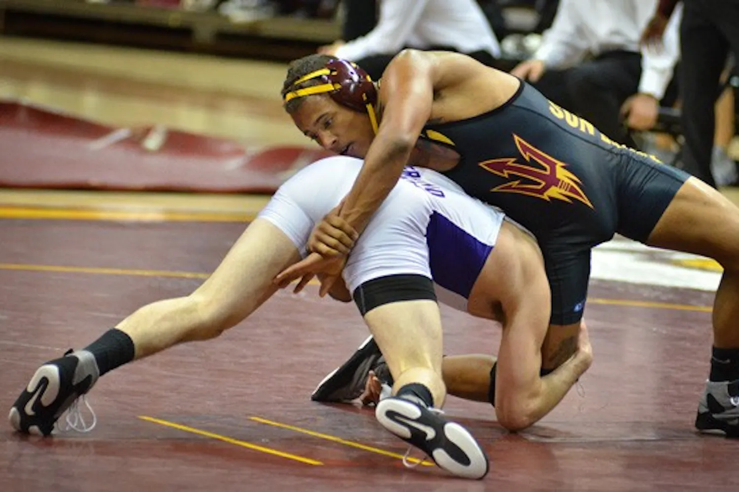 Redshirt sophomore Hans Rasmusson sprawls to avoid a shooting attacker. The wrestling team will try to avoid their first conference loss this weekend when they face Boise State and Utah Valley (Photo by Aaron Lavinsky)