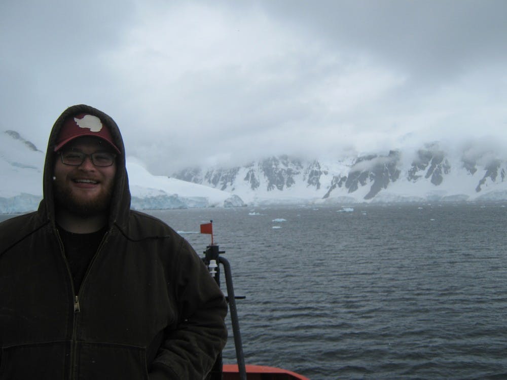 Connor Wetzel-Brown poses in front of Antarctica in the spring of 2016.