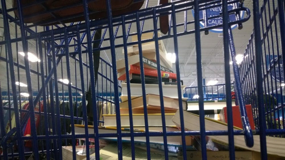 A tower of books grew in my thrift store shopping cart.