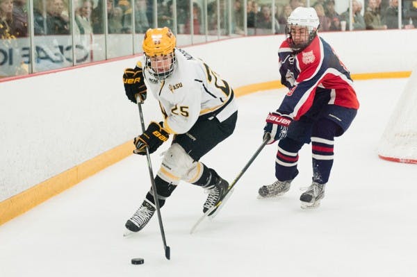 Senior forward Liam Norris skates with the puck in a game against Arizona on Saturday, Jan. 31, 2015, at Oceanside Ice Arena in Tempe. The Sun Devils defeated the Wildcats 7-2. (Ben Moffat/The State Press)