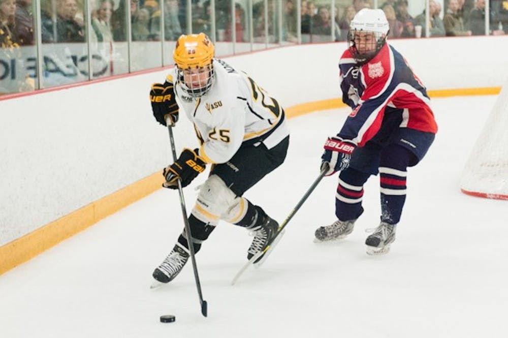 Senior forward Liam Norris skates with the puck in a game against Arizona on Saturday, Jan. 31, 2015, at Oceanside Ice Arena in Tempe. The Sun Devils defeated the Wildcats 7-2. (Ben Moffat/The State Press)