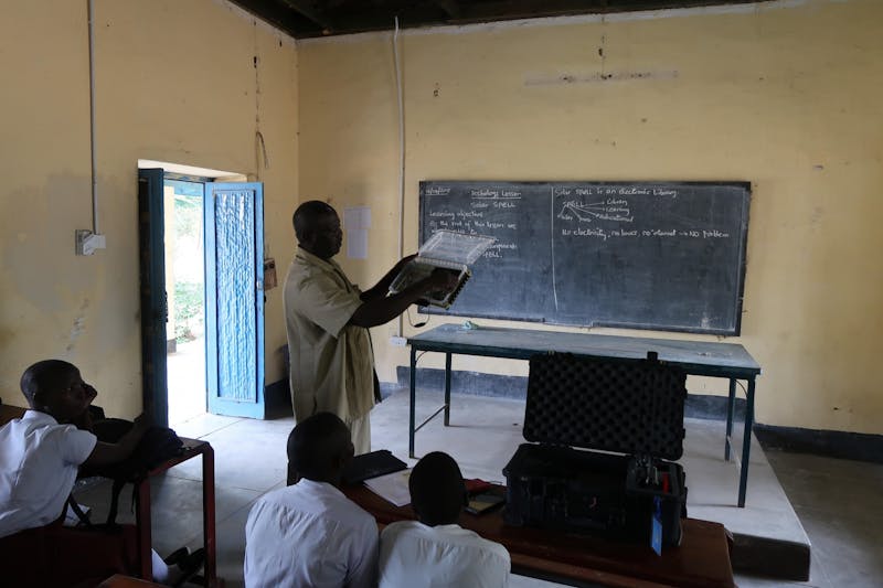 Mr. Philip Sunday Ephraim teaches their class at the Juba Girls Secondary School in Juba, South Sudan on May 16, 2018. Ephraim was one of three teachers from their school to attend a SolarSPELL training.&nbsp;