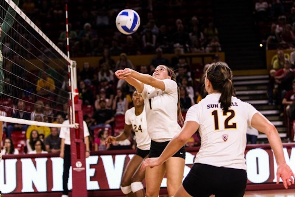 Junior setter Bianca Arellano sets the ball for junior outside hitter Macey Gardner at the beginning of the third set of the ASU vs Oregon volleyball game at the Wells Fargo Arena on Nov. 11, 2014. Arellano would set a career high for herself in that game with 62 assists. (Photo by Daniel Kwon)