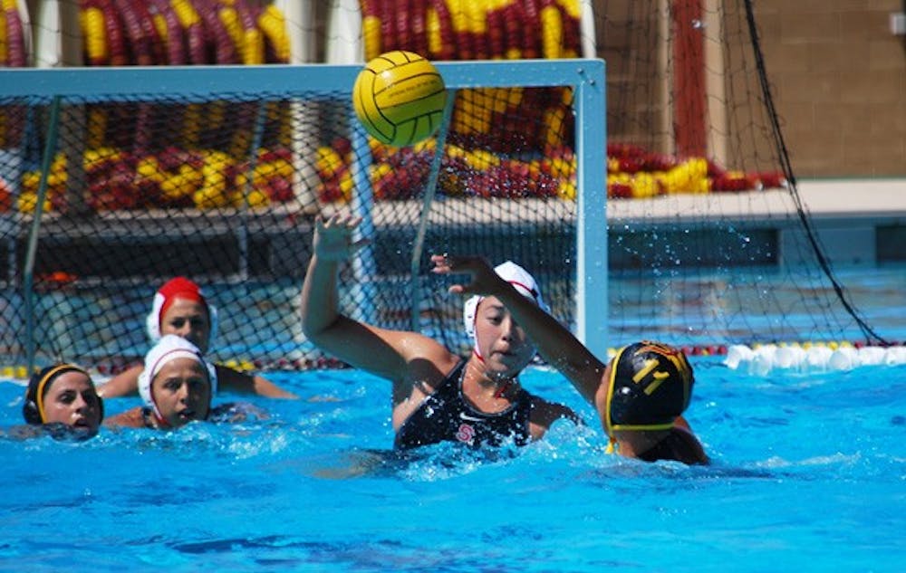Sophomore attacker Ao Gao passes a ball over a Stanford defender to a teammate on March 24. The ASU water polo team easily handled their competition and won all five games in the Brown Tournament. (Photo by Murphy Bannerman)