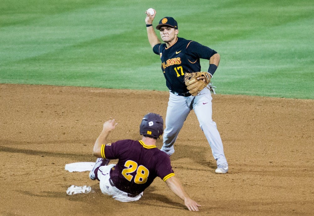 Junior infielder Frankie Rios (17) turns a double play, throwing out ASU junior first baseman David Greer (28), on Saturday, May 28, 2016, at Phoenix Municipal Stadium in Phoenix. The Trojans defeated the Sun Devils 6-2.