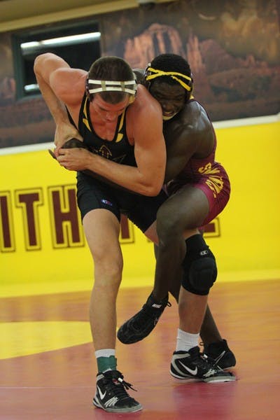 Redshirt senior Jake Meredith grapples with teammate and redshirt sophomore Kevin Radford in ASU’s annual Maroon vs. Gold match on Oct. 26. (Photo by Kyle Newman)