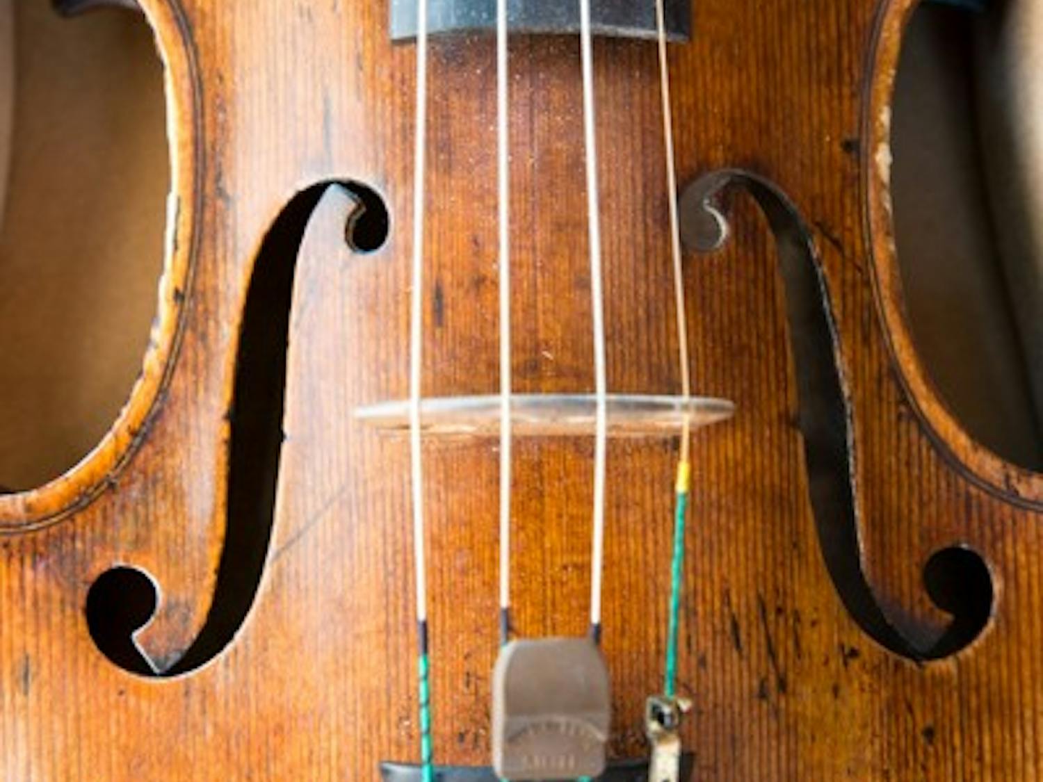 The violin that violin performance sophomore Xiangyuan Huang will perform with at Carnegie Hall sits in its case. The violin was made by Josephus Baldantonus and is rented by ASU to students on a semester-long basis. (Photo by Andrew Ybanez)