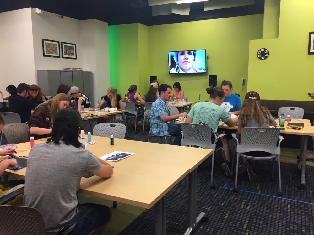 Students paint on canvases for Barrett's DIY Art Night on Tuesday, March 21, 2017.