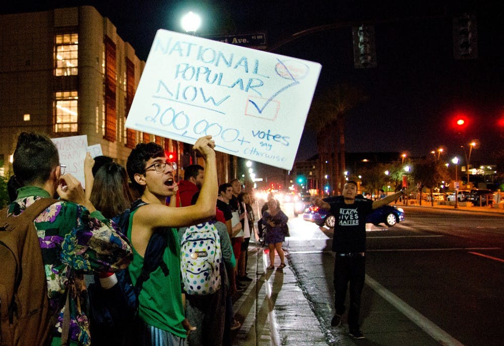 Anti-Trump protesters march down University Drive on Nov. 9, 2016.