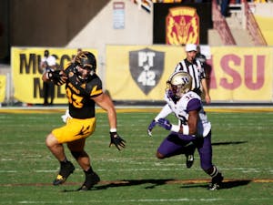 ASU redshirt junior tight end Kody Kohl evades the tackle of Washington sophomore safety Budda Baker in the second half of the Sun Devils' 27-17 win over the Huskies at Sun Devil Stadium on Nov. 14, 2015.