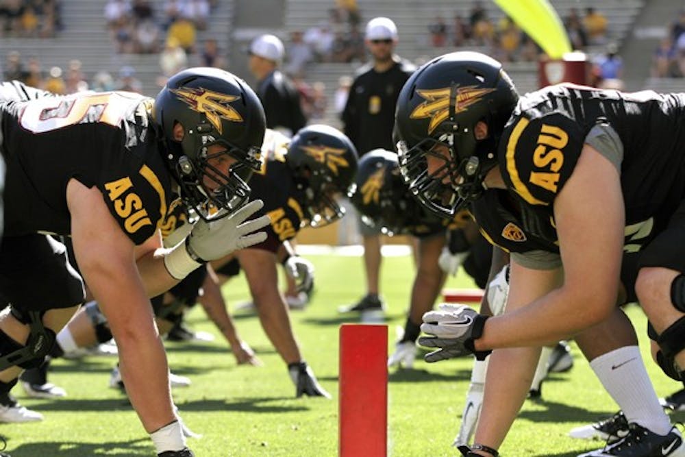 TAKING POSITION: The ASU football team lines up for a play during Wednesday's spring practice. The Sun Devils practiced in pads for the first time on Thursday. (Photo by Kyle Thompson)