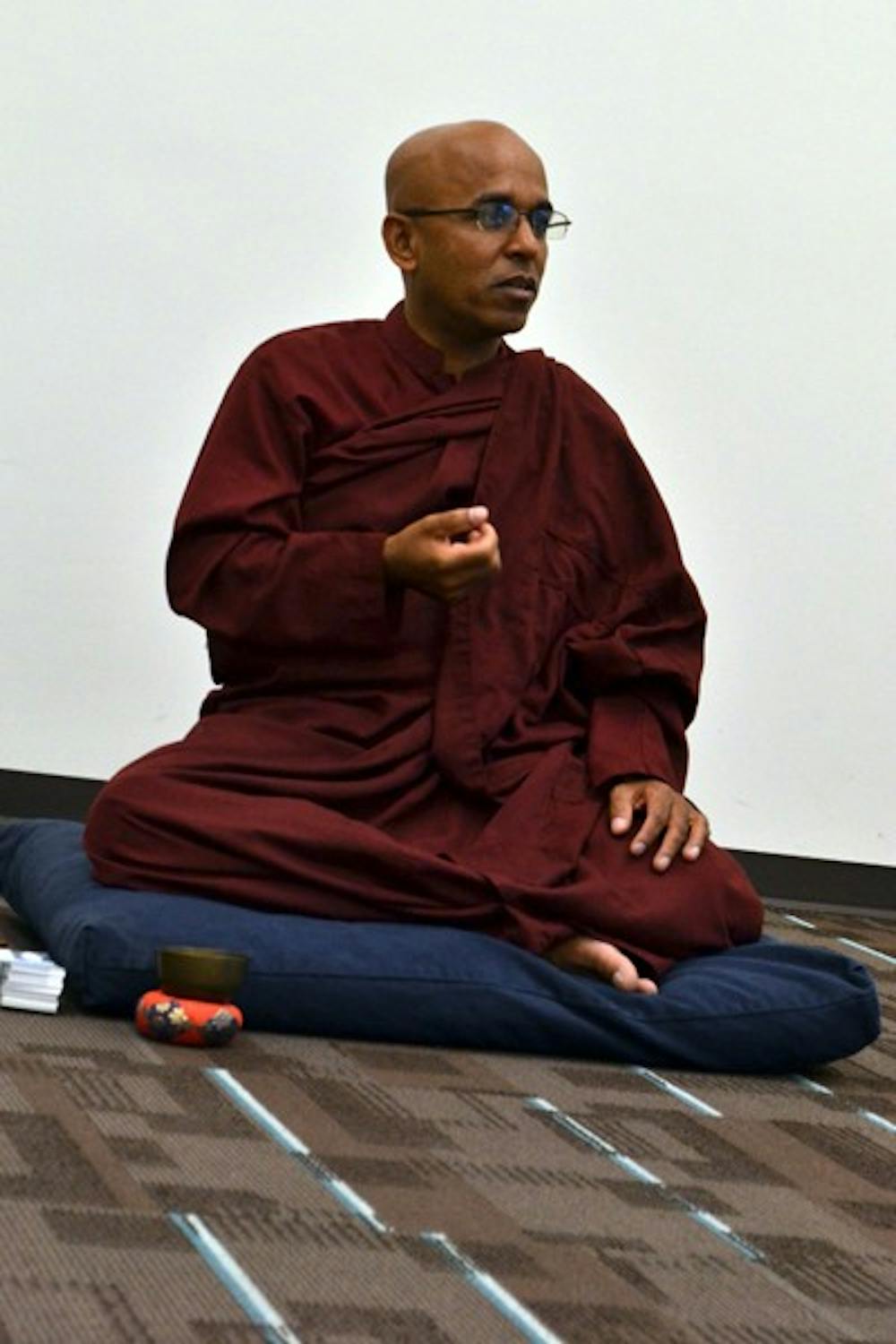 Buddhist Sangha Upasaka Culadasa clarifies the meaning behind meditation to a small group of participants in the Nursing and Health Innovation building on the Downtown campus Thursday afternoon. (Photo by Brittany Lea)