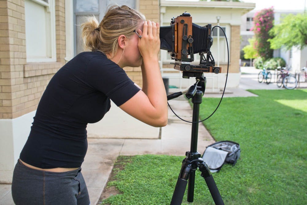 Photo senior Danielle Holman focuses a 4x5 film camera.
Photo by Josh Loeser