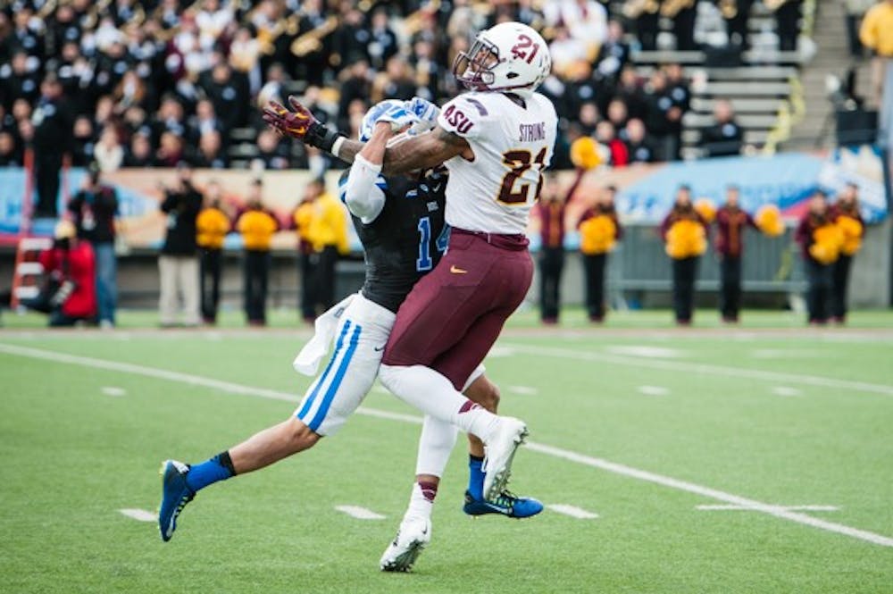 Redshirt junior wide receiver Jaelen Strong is fouled by Duke sophomore cornerback Bryon Fields in the Sun Bowl, Saturday, Dec. 27, 2014 at Sun Bowl Stadium in El Paso. The Sun Devils defeated the Blue Devils 36-31. (Ben Moffat/The State Press)
