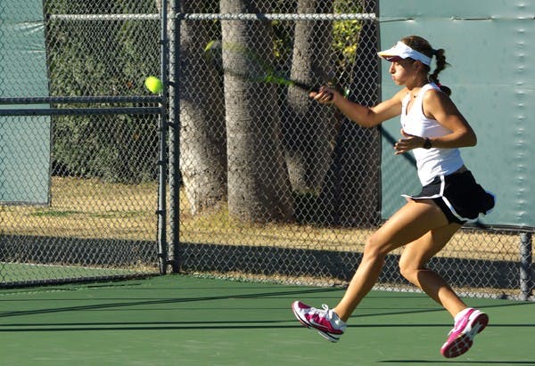 CLOSING OUT: Sophomore Jacqueline Cako returns a volley with an underhand swing during the Sun Devils’ home meet against Iowa State last January. ASU will compete in its last meet of the fall season at the team’s annual Arizona State Thunderbird Invitational over the weekend. (Photo by Nathan Meacham)