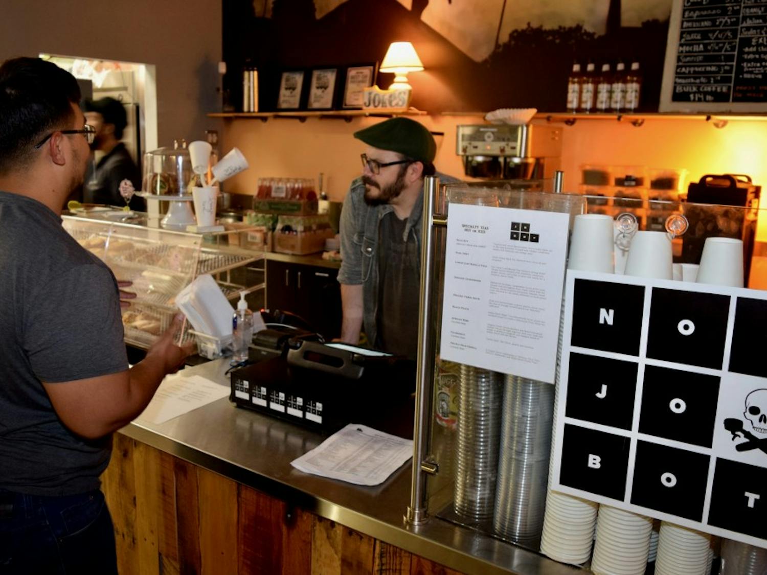 Barista Robert Zunigha takes a coffee order from Javier Gonzalez at Jobot Coffee's new location at Roosevelt Point in Downtown Phoenix, Arizona,&nbsp;on Jan. 23, 2017.