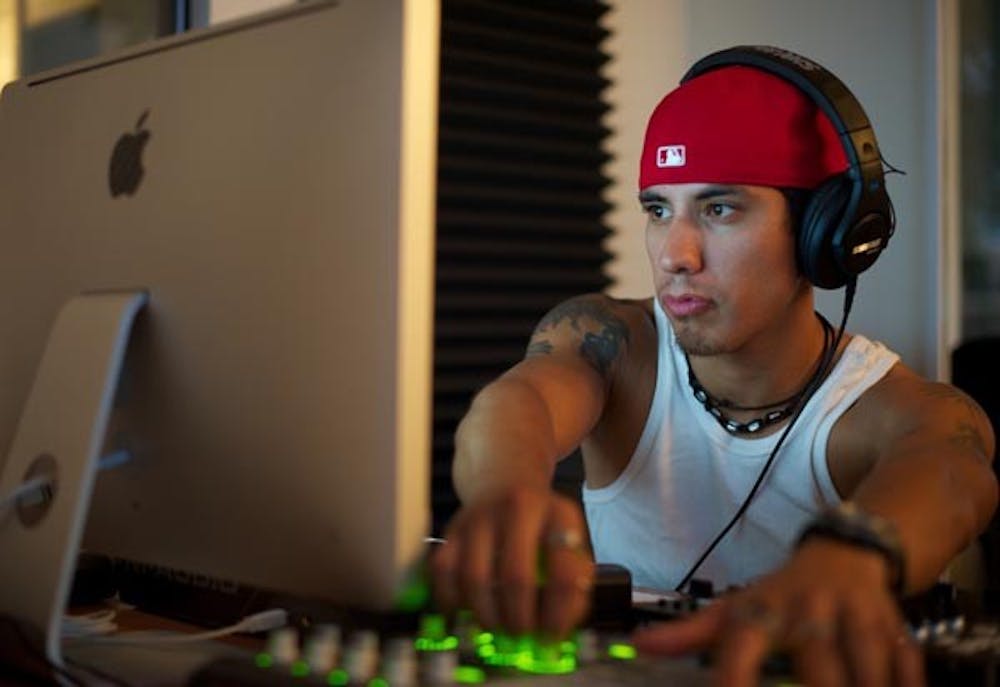 CREATING MUSIC: Sergio Castillo, a senior business communications major and graduate student of the Sequence music program, records a track in the studio. Sequence was founded by ASU alum (and current CEO) Brandon Weinberger, who graduated in 2009. (Photo by Michael Arellano)