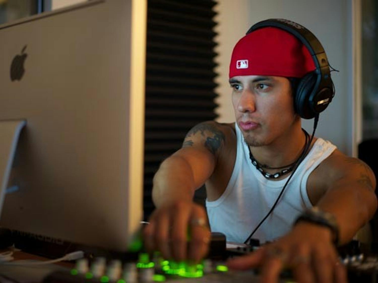 CREATING MUSIC: Sergio Castillo, a senior business communications major and graduate student of the Sequence music program, records a track in the studio. Sequence was founded by ASU alum (and current CEO) Brandon Weinberger, who graduated in 2009. (Photo by Michael Arellano)