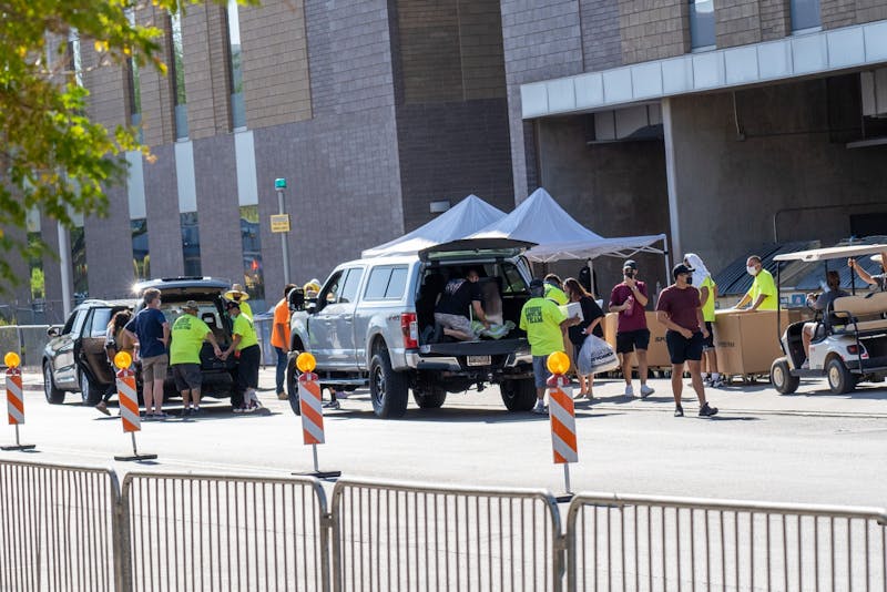 Volunteers unload cars during move-in on the ASU Tempe Campus on Saturday, Aug. 15, 2020.