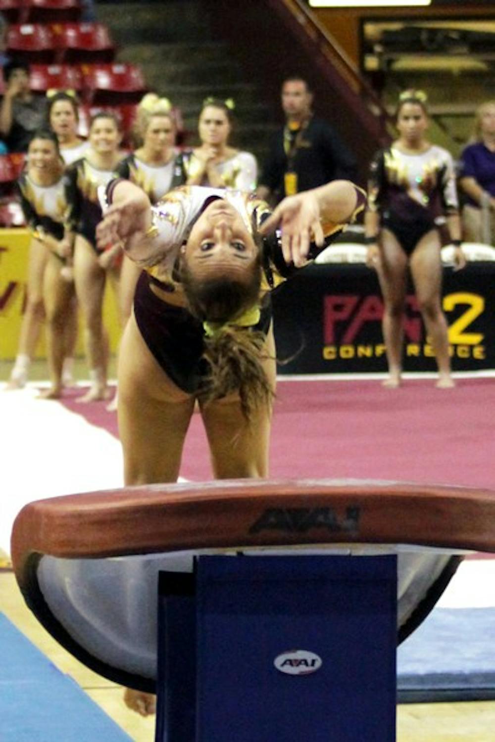 Junior Samantha Seaman takes one last look at the vault before going into her flip on March 15 in meet against Bridgeport. The meet against Bridgeport was Senior Night and Seaman’s first meet after her injury. (Photo by Arianna Grainey)
