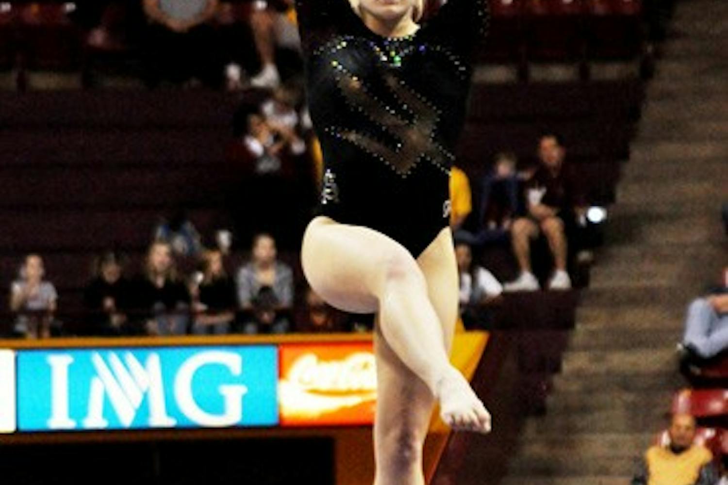 Finding Balance: Sophomore Amelia Rew performs on the beam for ASU during the Sun Devils’ victory over Brown on Friday in Tempe. A few shaky performances on beam were the only blip for the Sun Devils, who coasted to a victory over the Bears. (Photo by Sierra Smith)