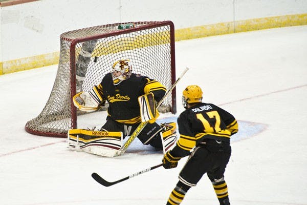 Junior goaltender Joseph D’Elia deflects a shot as sophomore forward Kale Dolinski waits for rebound during the Sun Devil’s 3-1 victory over UA on Nov. 3.
Photo courtesy of Michelle Hekle