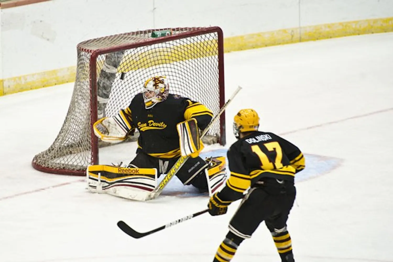 Junior goaltender Joseph D’Elia deflects a shot as sophomore forward Kale Dolinski waits for rebound during the Sun Devil’s 3-1 victory over UA on Nov. 3.
Photo courtesy of Michelle Hekle