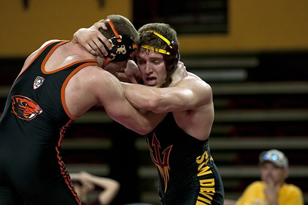 Wesley Moore grapples with his opponent in a match against Oregon State on Feb. 9. Moore won his bout, but the Sun Devils fell to Stanford Sunday. (Photo by Mario Mendez)