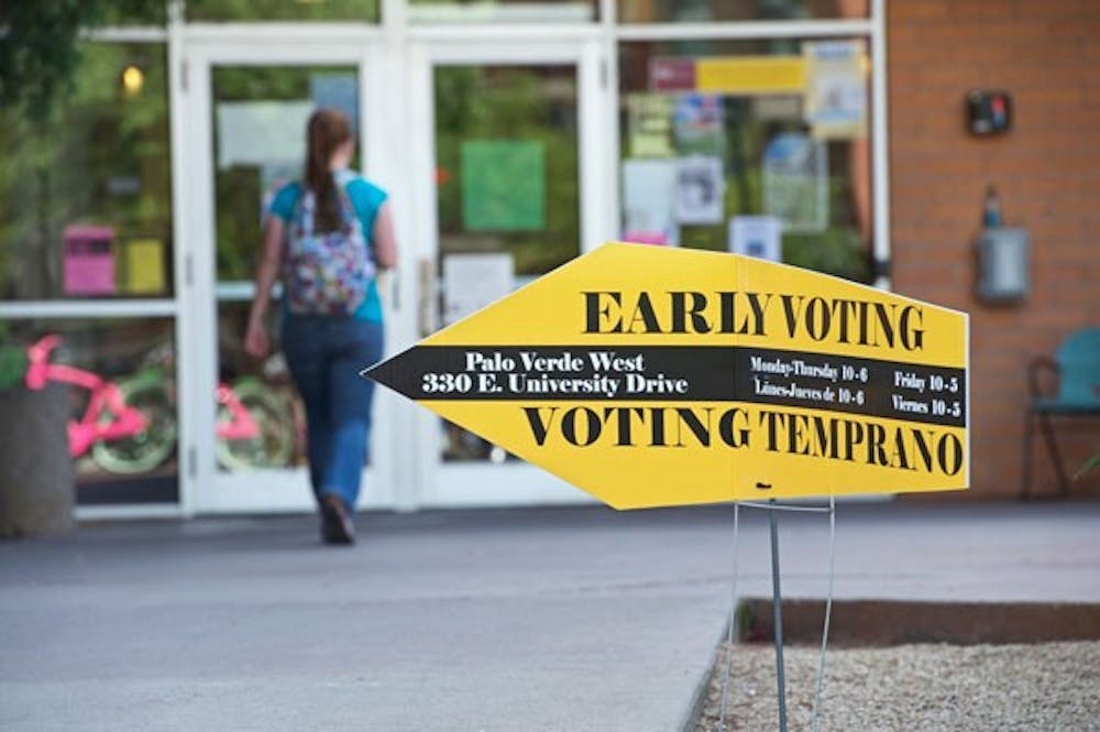 CAST YOUR BALLOT: A student enters the voting center to cast her ballot on Proposition 100 in Tempe's Palo Verde West office. Prop 100 would enact temporary one-cent increase in the existing sales tax to fund education and social programs. (Photo by Michael Arellano)