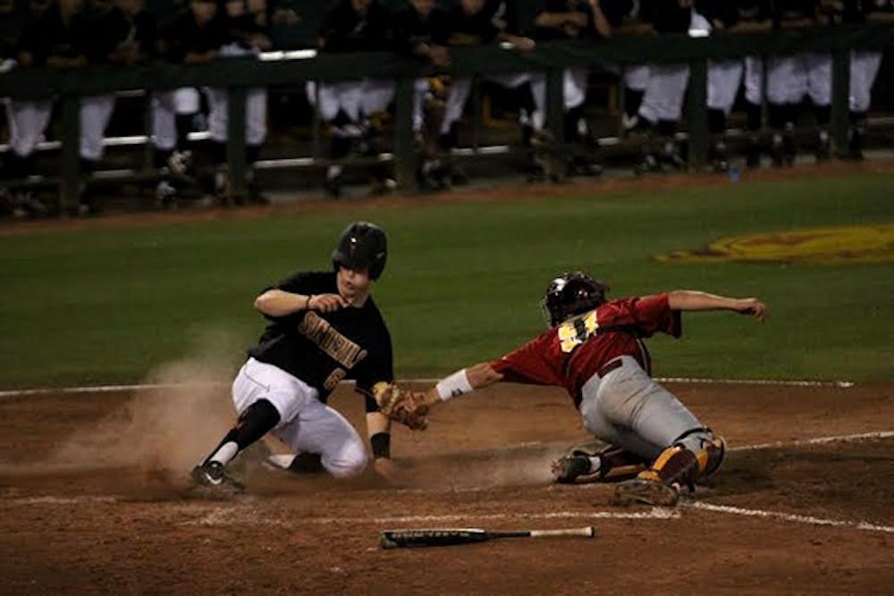 Sophomore catcher Brian Serven avoids the tag at home plate to score in the third inning of an ASU baseball game against USC on April 4, 2014. ASU won, 5-3. (Photo by Benjamin Margiott)
