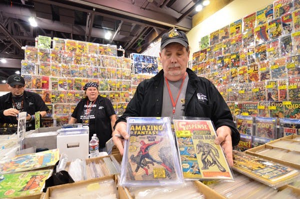 FIRST  APPEARANCE: Jamie Graham, owner of Graham Crackers Comics based in Chicago, shows off the rare comic books that debuted the popular characters Ironman and Spiderman. (Photo by Aaron Lavinsky)