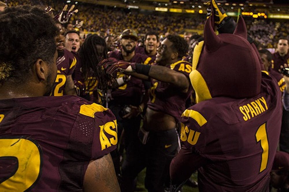 ASU football players celebrate with Sparky after their win against Utah on Saturday, Nov. 1, 2014. ASU defeated Utah in overtime 19-16. (Photo by Alexis Macklin)
