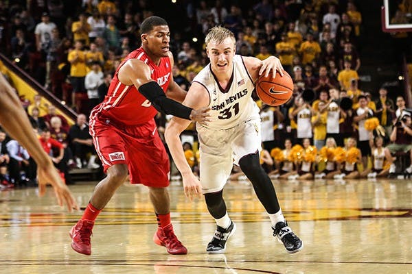 Junior forward Jonathan Gilling dribbles the ball up the court during a home game against Bradley. (Photo by Arianna Grainey)