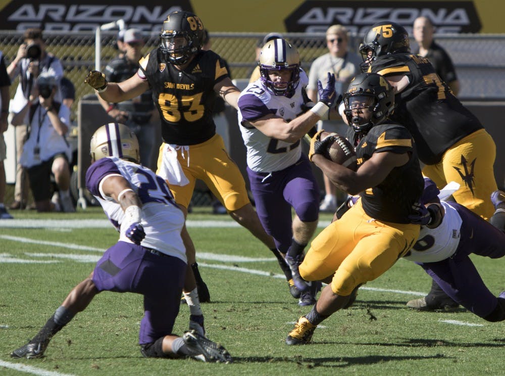 Sophomore running back Demario Richard (4) breaks a tackle in the second quarter against Washington on Saturday, Nov. 14, 2015, at Sun Devil Stadium in Tempe. 