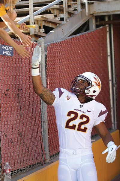 Redshirt senior running back James Morrison high-fives fans outside of Tillman Tunnel during the ASU football team’s Spring Game in April. (Photo by Sam Rosenbaum)