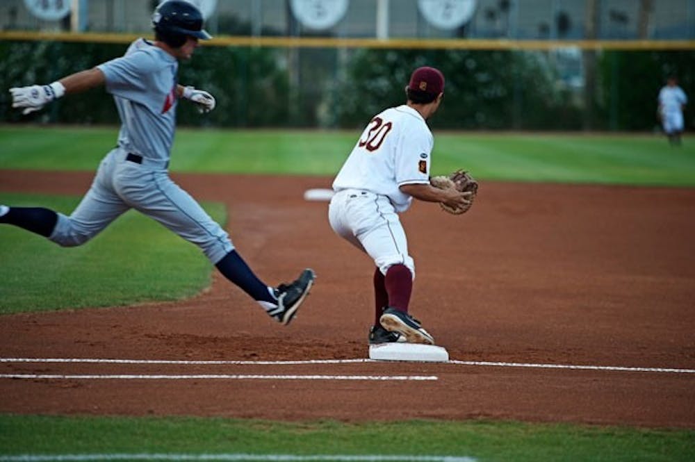 JUST IN TIME: ASU sophomore infielder Riccio Torrez catches an out at first base during the Sun Devils' 4-2 loss to UA on Tuesday night at Packard Stadium. (Photo by Michael Arellano)