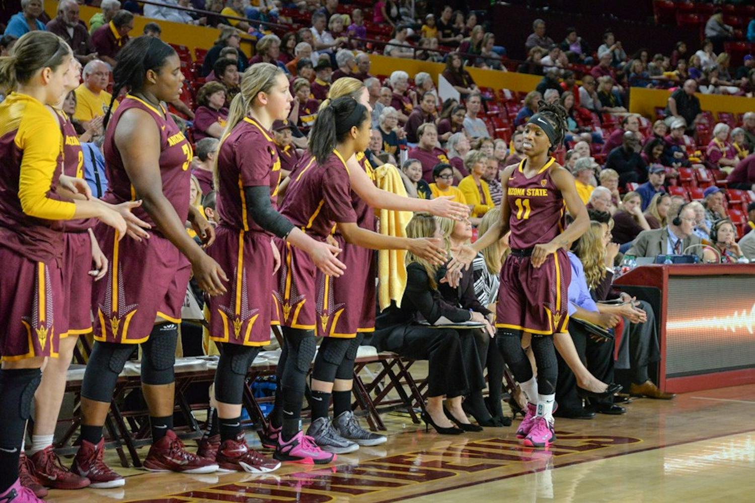 Junior guard Peace Amukamara is greeted by her teammates as she returns to the bench during Friday's game. The Sun Devils would go on to win the game 45-42 over the Utes. on Feb. 27, 2015 at the Wells Fargo Arena in Tempe. (J. Bauer-Leffler/The State Press)