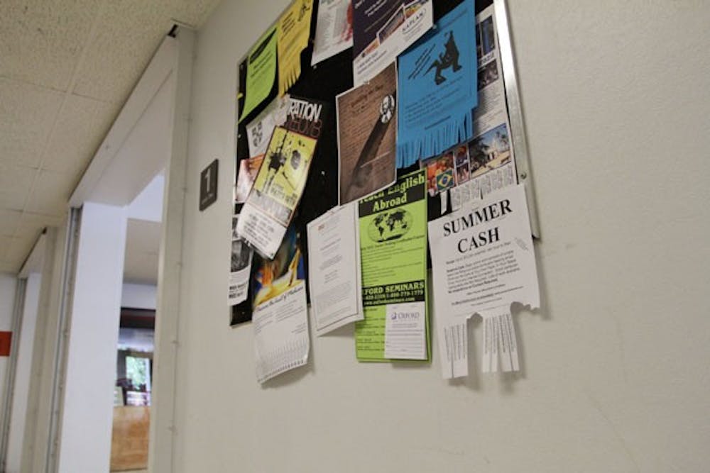 ODD JOBS: Billboards, such as ones at the Homer G. Language and Literature building, are filled with flyers for full- and part-time jobs for students who want to earn extra cash over the summer. (Photo by Nikolai de Vera)