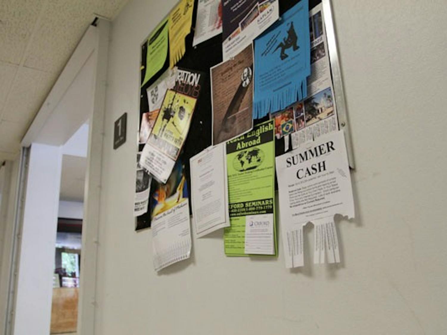 ODD JOBS: Billboards, such as ones at the Homer G. Language and Literature building, are filled with flyers for full- and part-time jobs for students who want to earn extra cash over the summer. (Photo by Nikolai de Vera)