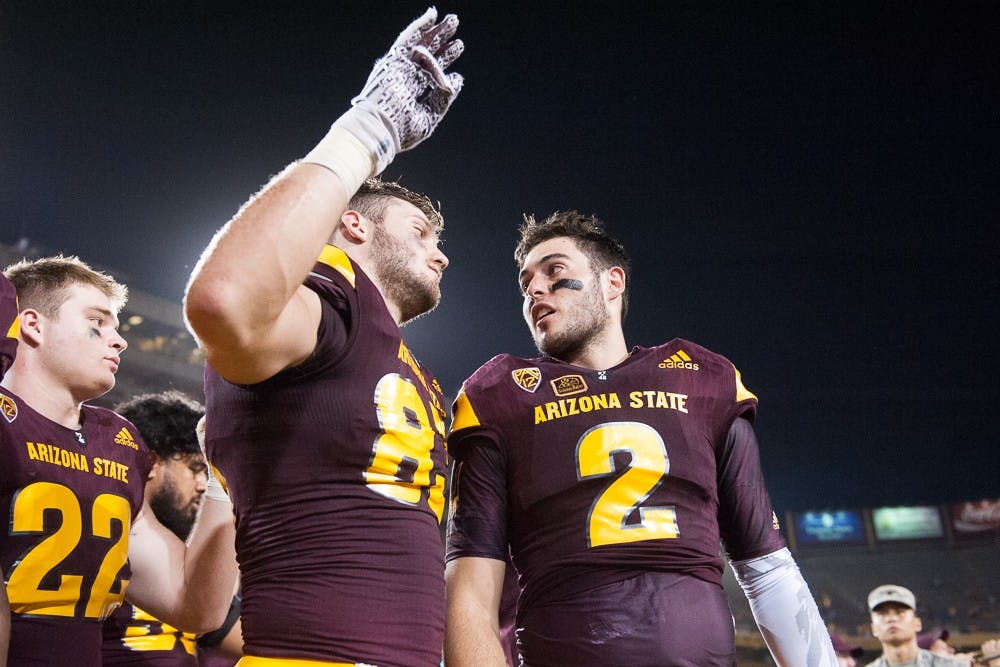 Redshirt junior tight end Kody Kohl (left) and redshirt senior quarterback Mike Bercovici celebrate after defeating Cal Poly 35-21 on Saturday, Sept. 12, 2015, at Sun Devil Stadium in Tempe.