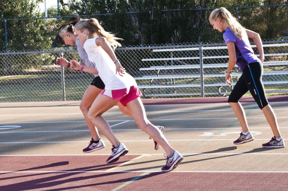Junior Shelby Houlihan, freshman Miranda Kewley and junior Payton Schutte start to run sprints on the Joe Selleh Track. The ASU cross-country team finished just short of the qualifications for the NCAA Championship for the fourth year in a row. (Photo by Katie Dunphy)