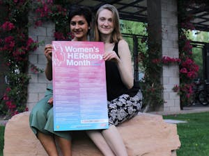 Students Asha Ramakumar and Rachel Fletcher pose with a poster about women's events at ASU on March 21, 2017.