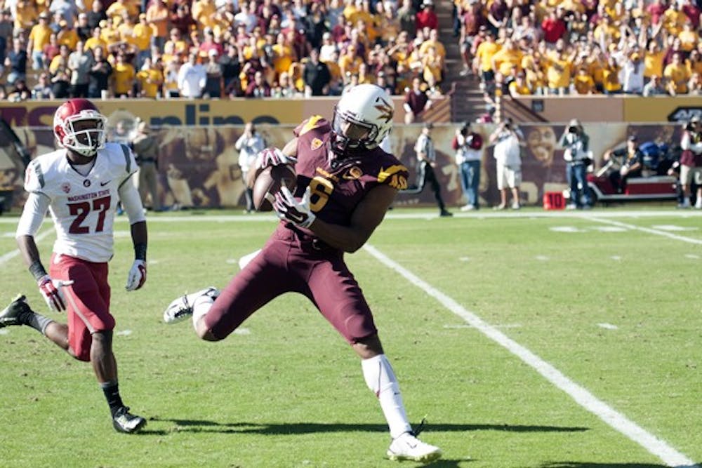 Wide receiver Cameron Smith catches a remote pass from quarterback Taylor Kelly. ASU beat Washington State 52-31 at Sun Devil Stadium on Saturday, Nov. 22, 2014. (Photo by Mario Mendez)