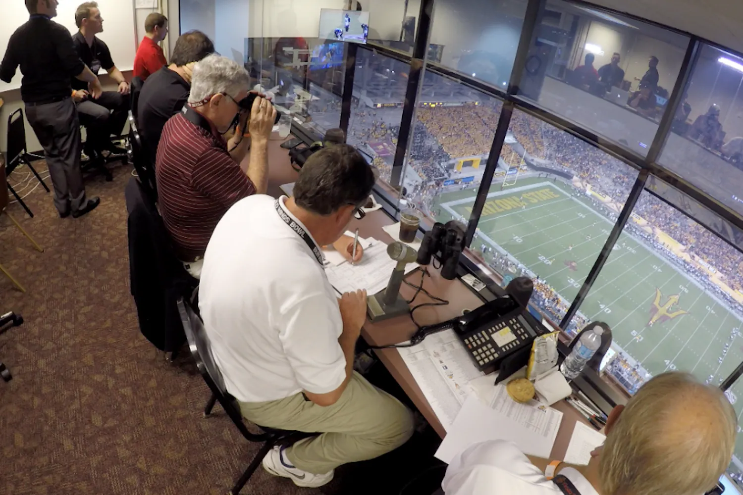 Members of the stat crew in the press box work during an ASU football game against Northern Arizona University on Saturday, Sept. 4, 2016. 