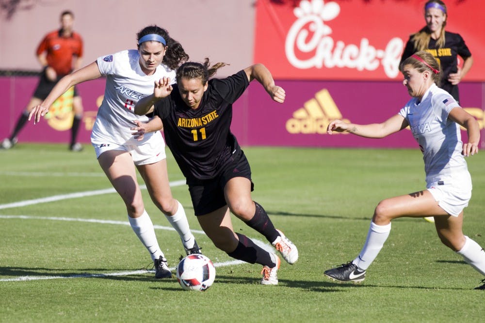 ASU freshman forward Olivia Hernandez (11) fights off two Wildcat defenders to try and get a shot off in the first half of a game versus the Arizona Wildcats in Sun Devil Soccer Stadium in Tempe, Arizona, on Friday, Nov. 4, 2016. 