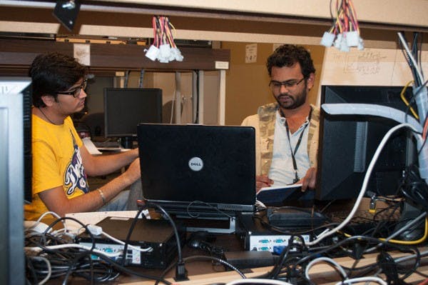 Imtiyaz Hussain and Koshik Samoth, both computer science graduate students, work on a group project in the engineering lab of the Ira A. Fulton Schools of Engineering on the Tempe campus on Sunday afternoon. The engineering program is currently focusing on getting their first-year students more experience to better prepare them for the work force after graduation. (Photo by Danielle Gregory)