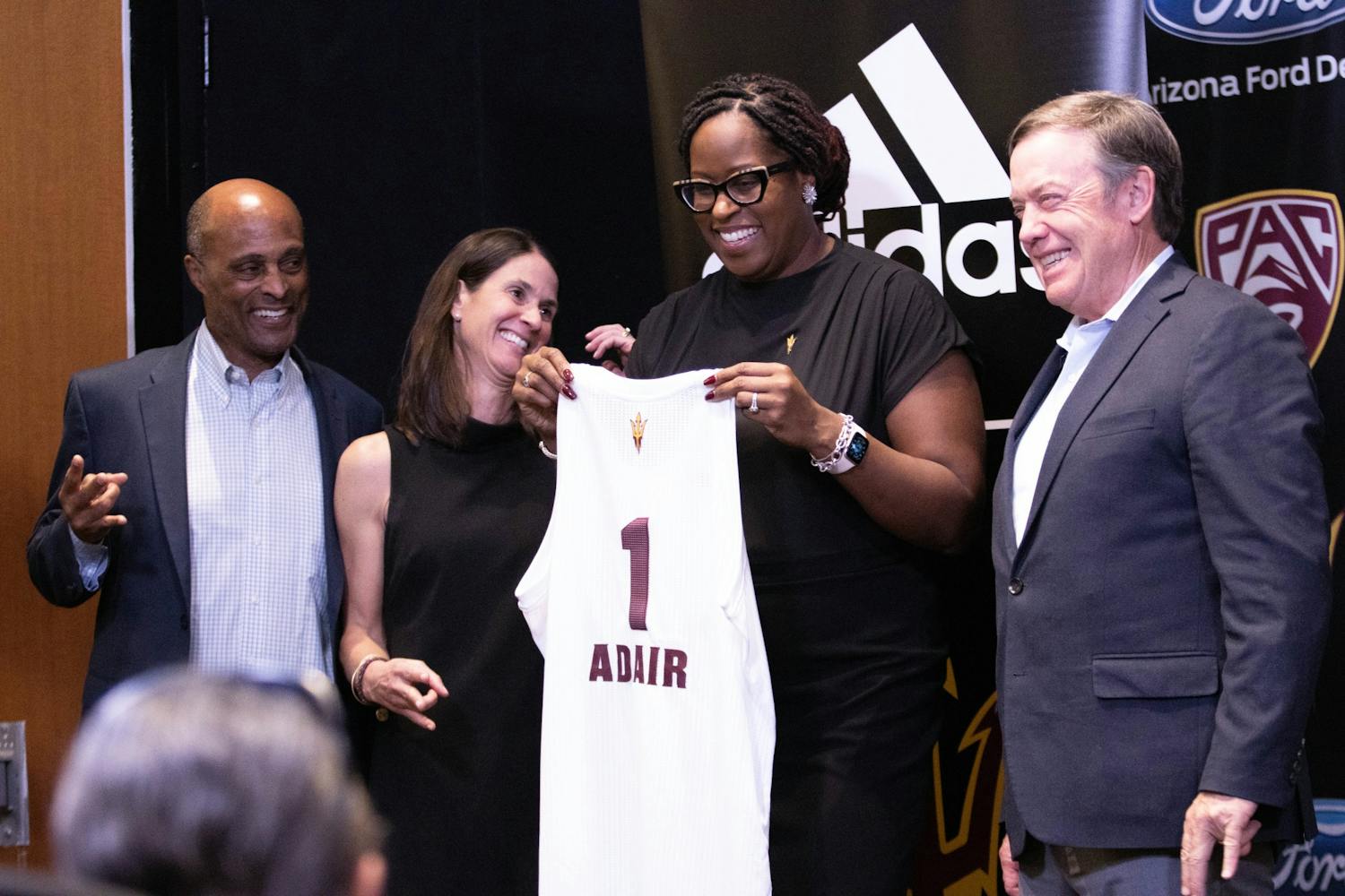 Natasha Adair is pictured holding a jersey.&nbsp;